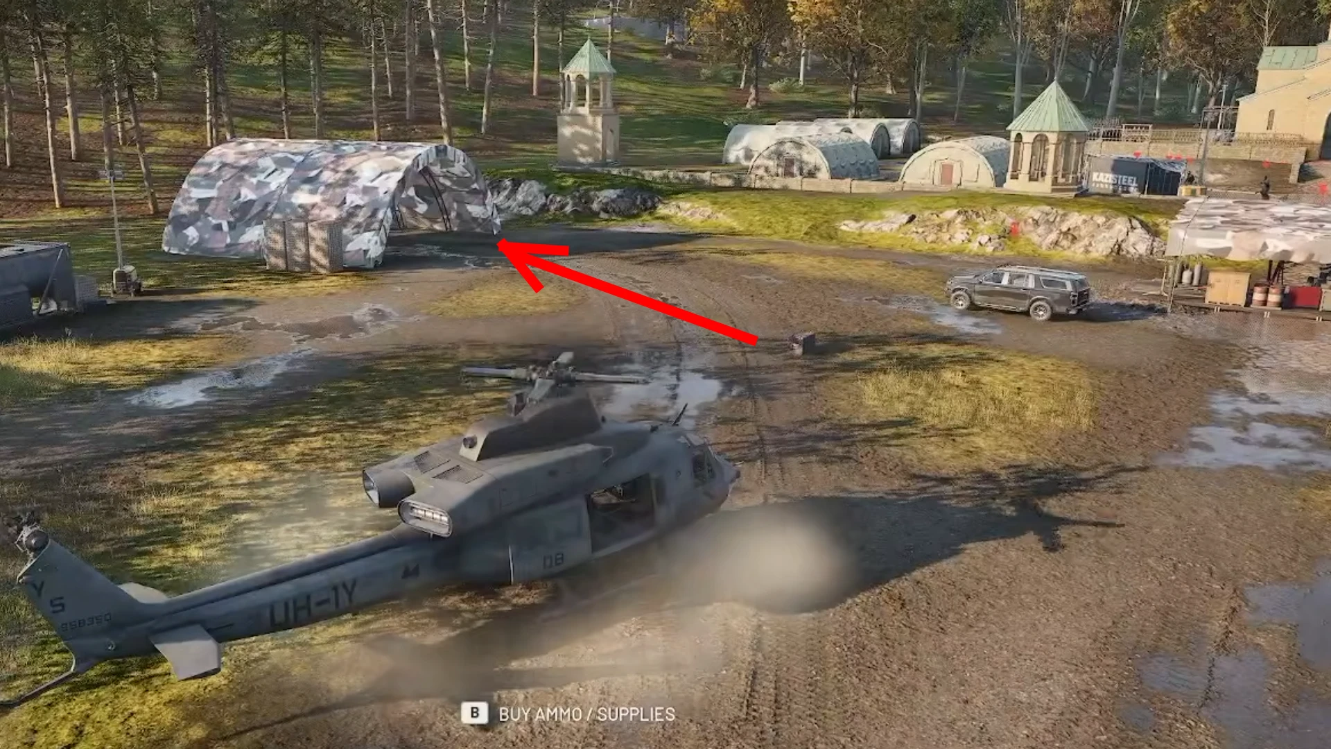 WARDOGS base with a red arrow pointing at the camouflaged tent where the team spawn vehicle appears